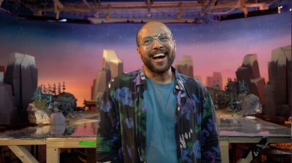 Dean Atta in front of the TBBIP paradise set