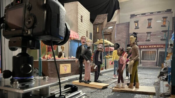 A shot of the BTS of the market set in TBBIP with puppets standing on the road